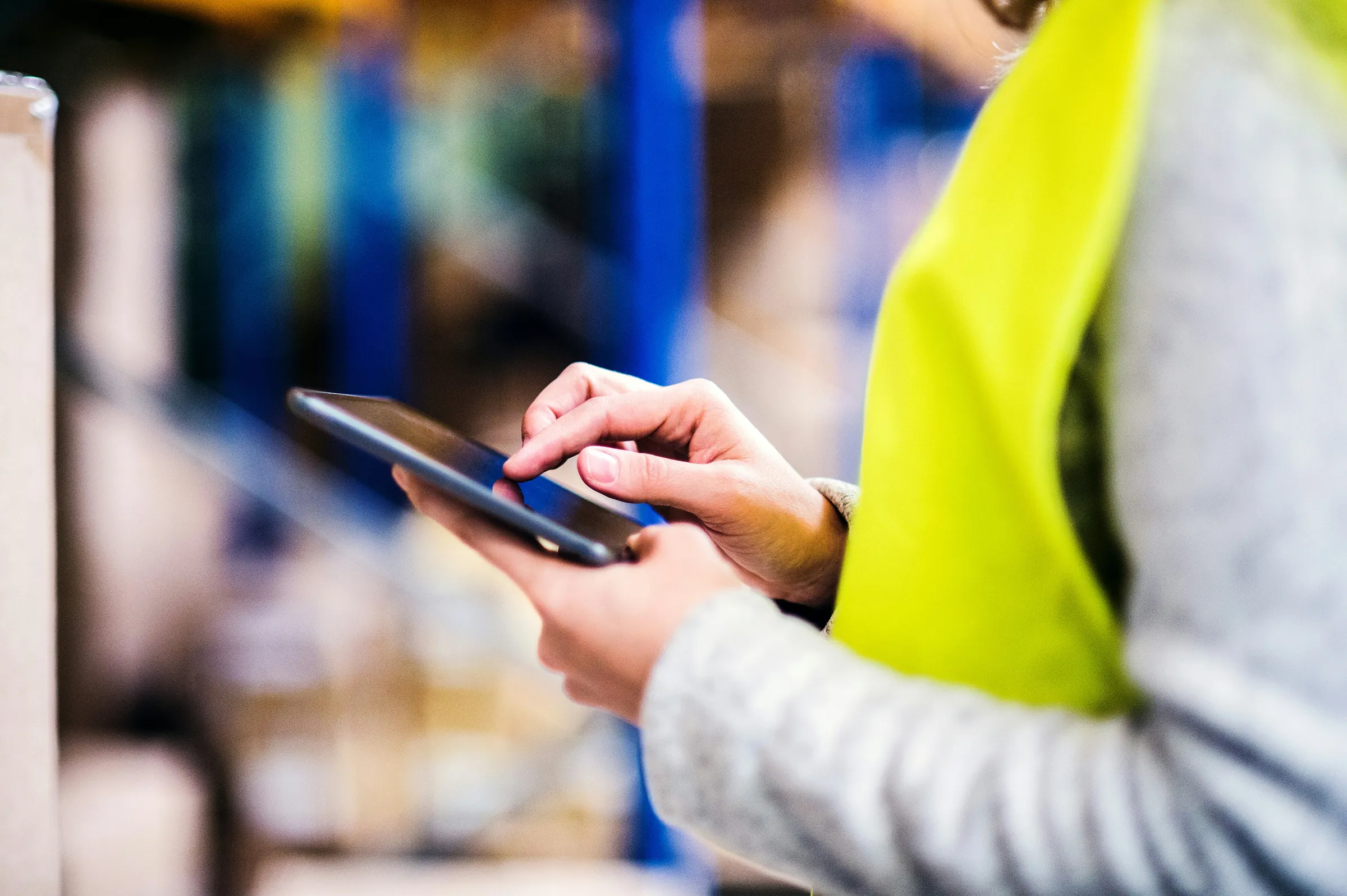 person in warning vest using touch device